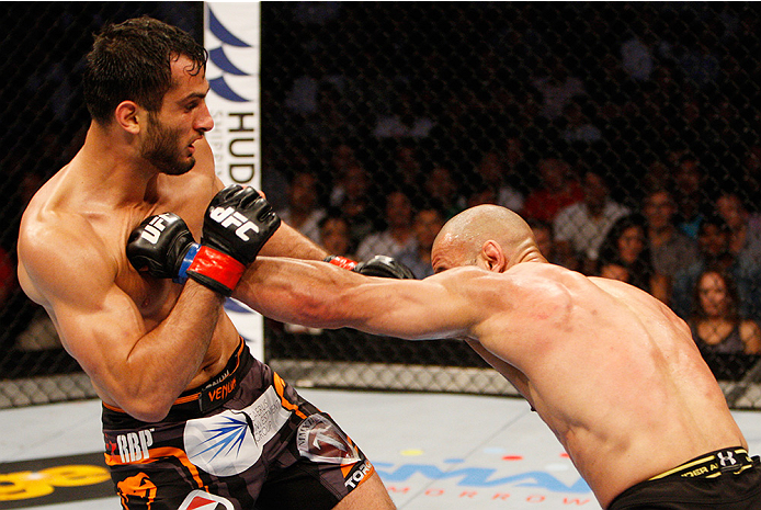 MANILA, PHILIPPINES - MAY 16: Costas Philippou of the United States punches Gegard Mousasi of the Netherlands in their middleweight fight during the UFC Fight Night event at the Mall of Asia Arena on May 16, 2015 in Manila, Philippines. (Photo by Mitch V