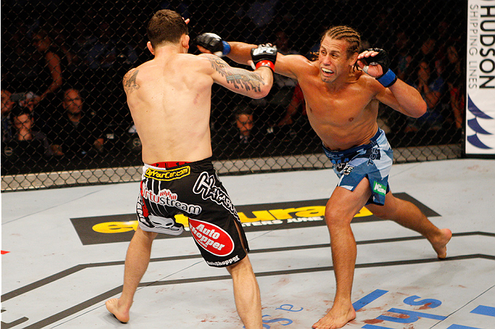MANILA, PHILIPPINES - MAY 16: Uriah Faber of the United States throws a punch at Frankie Edgar of the United States in their featherweight fight during the UFC Fight Night event at the Mall of Asia Arena on May 16, 2015 in Manila, Philippines. (Photo by M