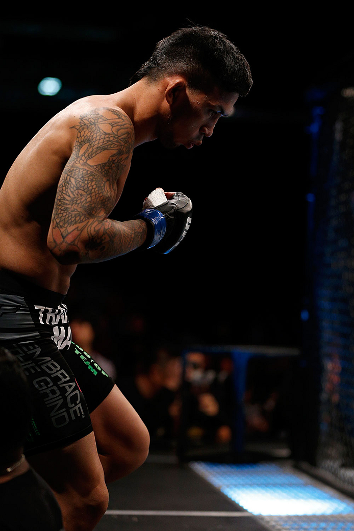 SINGAPORE - JANUARY 04: Russell Doane enters the Octagon before his bantamweight bout against Leandro Issa during the UFC Fight Night event at the Marina Bay Sands Resort on January 4, 2014 in Singapore. (Photo by Josh Hedges/Zuffa LLC/Zuffa LLC via Gett