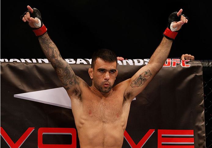 SINGAPORE - JANUARY 04: Leandro Issa stands in the Octagon before his bantamweight bout against Russell Doane during the UFC Fight Night event at the Marina Bay Sands Resort on January 4, 2014 in Singapore. (Photo by Josh Hedges/Zuffa LLC/Zuffa LLC via G