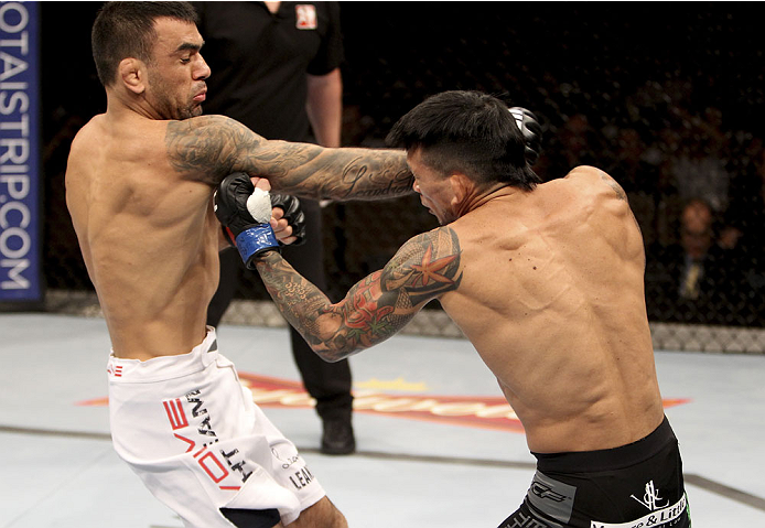 SINGAPORE - JANUARY 04: (L to R)Leandro Issa and Russell Doane face off in their bantamweight bout during the UFC Fight Night event at the Marina Bay Sands Resort on January 4, 2014 in Singapore. (Photo by Mitch Viquez/Zuffa LLC/Zuffa LLC via Getty Image