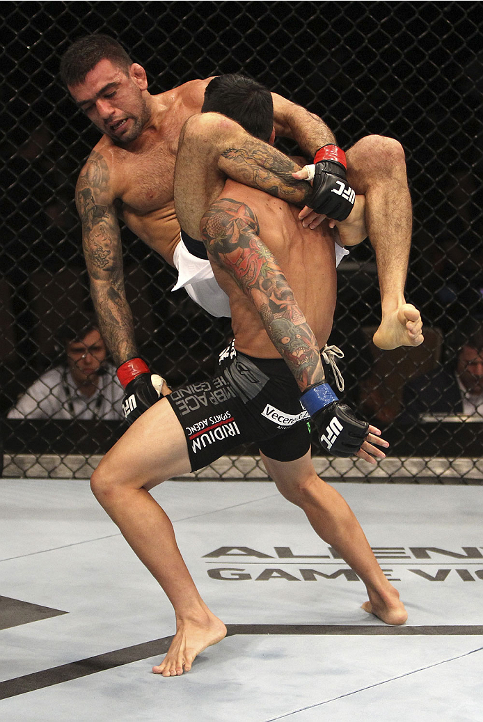 SINGAPORE - JANUARY 04: Russell Doane goes for a takedown on Leandro Issa in their bantamweight bout during the UFC Fight Night event at the Marina Bay Sands Resort on January 4, 2014 in Singapore. (Photo by Mitch Viquez/Zuffa LLC/Zuffa LLC via Getty Ima
