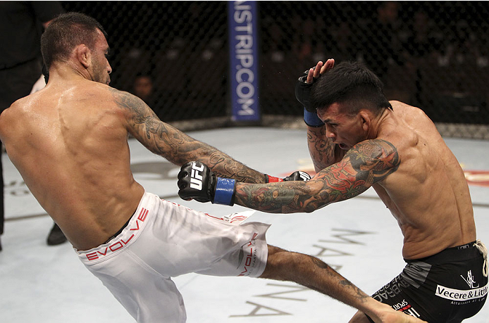 SINGAPORE - JANUARY 04: (L to R) Leandro Issa and Russell Doane face off in their bantamweight bout during the UFC Fight Night event at the Marina Bay Sands Resort on January 4, 2014 in Singapore. (Photo by Mitch Viquez/Zuffa LLC/Zuffa LLC via Getty Imag