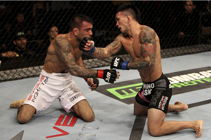 SINGAPORE - JANUARY 04: (L and R)Leandro Issa and Russell Doane face off in their bantamweight bout during the UFC Fight Night event at the Marina Bay Sands Resort on January 4, 2014 in Singapore. (Photo by Mitch Viquez/Zuffa LLC/Zuffa LLC via Getty Imag