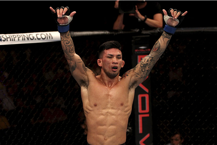 SINGAPORE - JANUARY 04: Russell Doane celebrates his win over Leandro Issa in their bantamweight bout during the UFC Fight Night event at the Marina Bay Sands Resort on January 4, 2014 in Singapore. (Photo by Mitch Viquez/Zuffa LLC/Zuffa LLC via Getty Im