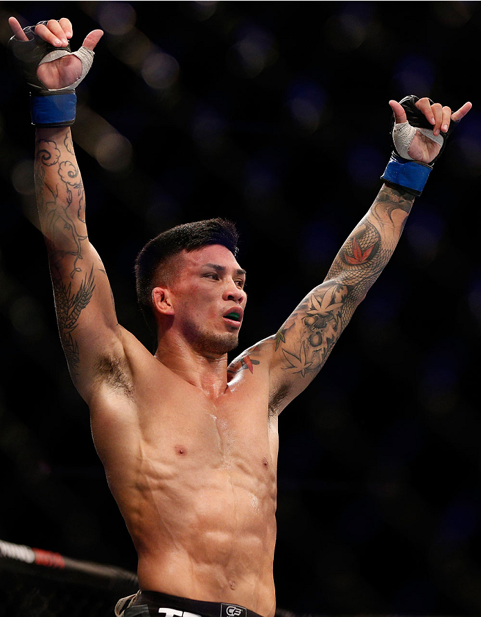 SINGAPORE - JANUARY 04: Russell Doane reacts after his submission victory over Leandro Issa in their bantamweight bout during the UFC Fight Night event at the Marina Bay Sands Resort on January 4, 2014 in Singapore. (Photo by Josh Hedges/Zuffa LLC/Zuffa