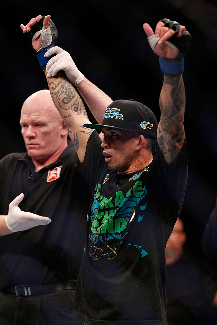SINGAPORE - JANUARY 04: Russell Doane reacts after his submission victory over Leandro Issa in their bantamweight bout during the UFC Fight Night event at the Marina Bay Sands Resort on January 4, 2014 in Singapore. (Photo by Josh Hedges/Zuffa LLC/Zuffa
