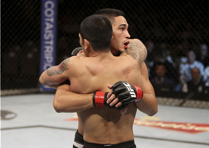 SINGAPORE - JANUARY 04: (facing) Dustin Kimura hugs Jon Delos Reyes after his victory in their bantamweight bout during the UFC Fight Night event at the Marina Bay Sands Resort on January 4, 2014 in Singapore. (Photo by Mitch Viquez/Zuffa LLC/Zuffa LLC v