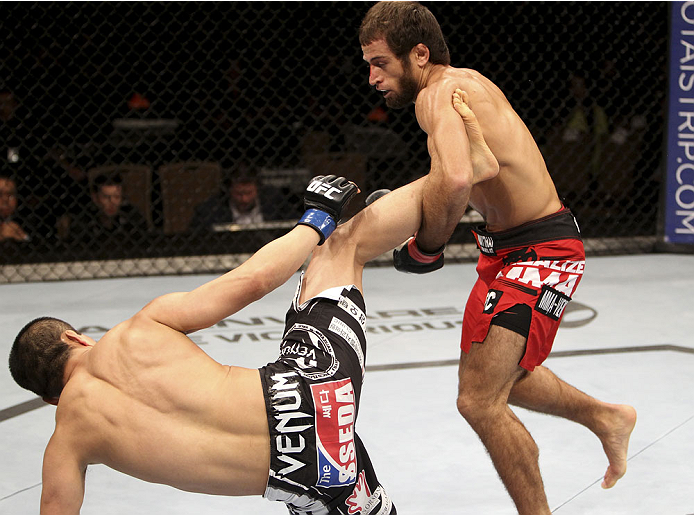 SINGAPORE - JANUARY 04: Mairbek Taisumov takes down Bang Tae Hyun in their lightweight bout during the UFC Fight Night event at the Marina Bay Sands Resort on January 4, 2014 in Singapore. (Photo by Mitch Viquez/Zuffa LLC/Zuffa LLC via Getty Images)
