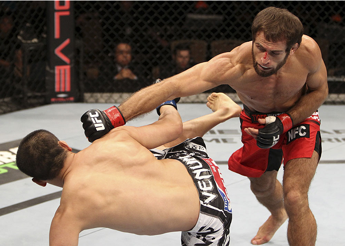 SINGAPORE - JANUARY 04: Mairbek Taisumov goes for a punch on Bang Tae Hyun in their lightweight bout during the UFC Fight Night event at the Marina Bay Sands Resort on January 4, 2014 in Singapore. (Photo by Mitch Viquez/Zuffa LLC/Zuffa LLC via Getty Ima