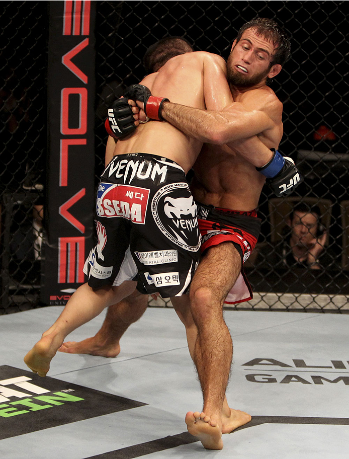 SINGAPORE - JANUARY 04: (L to R) Bang Tae Hyun and Mairbek Taisumov face-off in their lightweight bout during the UFC Fight Night event at the Marina Bay Sands Resort on January 4, 2014 in Singapore. (Photo by Mitch Viquez/Zuffa LLC/Zuffa LLC via Getty