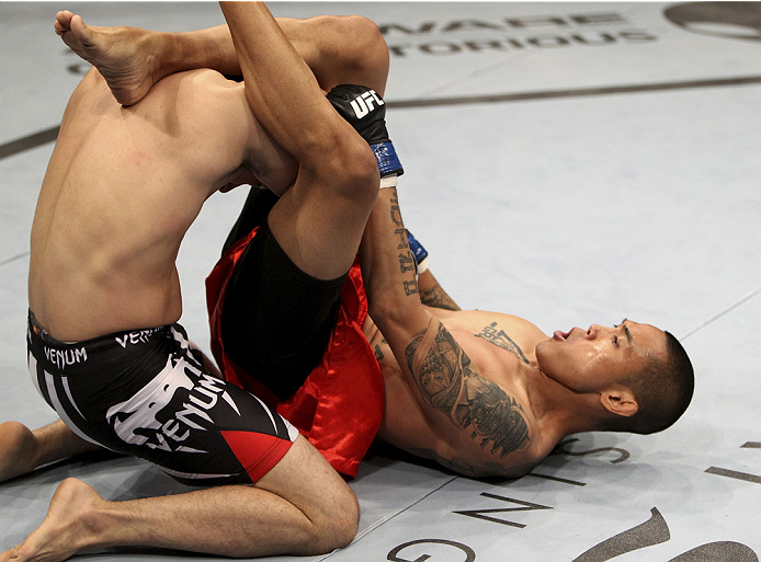 SINGAPORE - JANUARY 04: David Galera goes for a submission attempt on Royston Wee in their bantamweight bout during the UFC Fight Night event at the Marina Bay Sands Resort on January 4, 2014 in Singapore. (Photo by Mitch Viquez/Zuffa LLC/Zuffa LLC via G