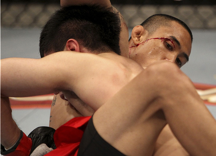 SINGAPORE - JANUARY 04: David Galera suffers a little blood from his eye against Royston Wee in their bantamweight bout during the UFC Fight Night event at the Marina Bay Sands Resort on January 4, 2014 in Singapore. (Photo by Mitch Viquez/Zuffa LLC/Zuff