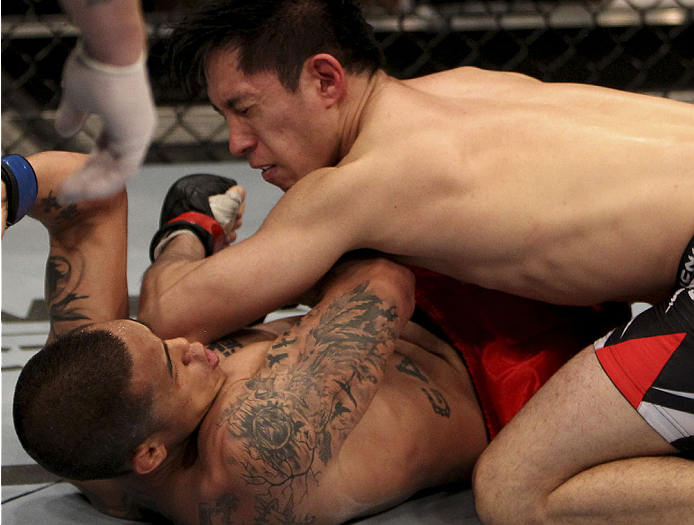 SINGAPORE - JANUARY 04: Royston Wee lands an elbow on David Galera in their bantamweight bout during the UFC Fight Night event at the Marina Bay Sands Resort on January 4, 2014 in Singapore. (Photo by Mitch Viquez/Zuffa LLC/Zuffa LLC via Getty Images)