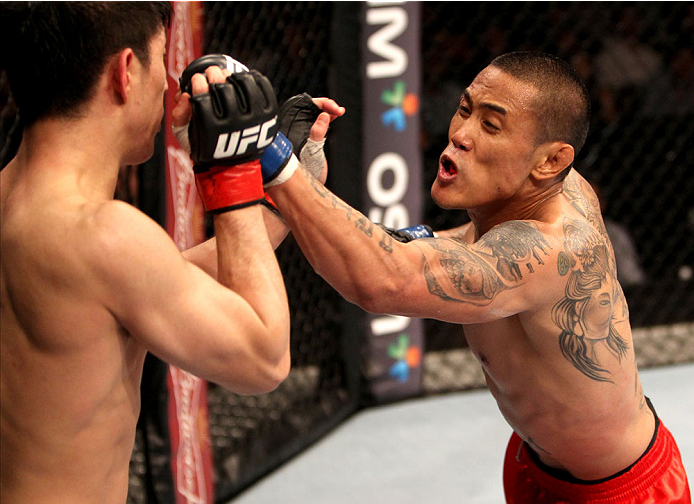 SINGAPORE - JANUARY 04: David Galera goes for a punch on Royston Wee in their bantamweight bout during the UFC Fight Night event at the Marina Bay Sands Resort on January 4, 2014 in Singapore. (Photo by Mitch Viquez/Zuffa LLC/Zuffa LLC via Getty Images)