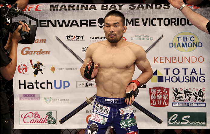 SINGAPORE - JANUARY 04: Katsunori Kikuno stands in front of his banner before his lightweight bout with Quinn Mulhern during the UFC Fight Night event at the Marina Bay Sands Resort on January 4, 2014 in Singapore. (Photo by Mitch Viquez/Zuffa LLC/Zuffa