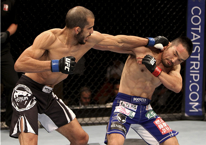 SINGAPORE - JANUARY 04: Quinn Mulhern lands a punch on Katsunori Kikuno in their lightweight bout during the UFC Fight Night event at the Marina Bay Sands Resort on January 4, 2014 in Singapore. (Photo by Mitch Viquez/Zuffa LLC/Zuffa LLC via Getty Images