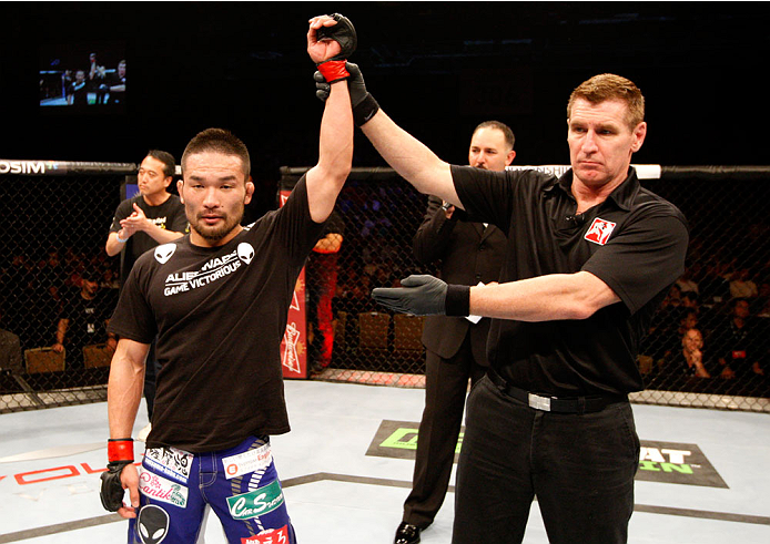 SINGAPORE - JANUARY 04: Katsunori Kikuno wins his lightweight bout against Quinn Mulhern during the UFC Fight Night event at the Marina Bay Sands Resort on January 4, 2014 in Singapore. (Photo by Mitch Viquez/Zuffa LLC/Zuffa LLC via Getty Images)