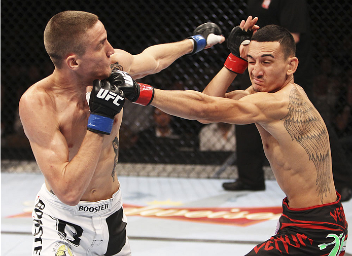 SINGAPORE - JANUARY 04: (L-R) Will Chope and Max Holloway face off in their featherweight bout during the UFC Fight Night event at the Marina Bay Sands Resort on January 4, 2014 in Singapore. (Photo by Mitch Viquez/Zuffa LLC/Zuffa LLC via Getty Images)