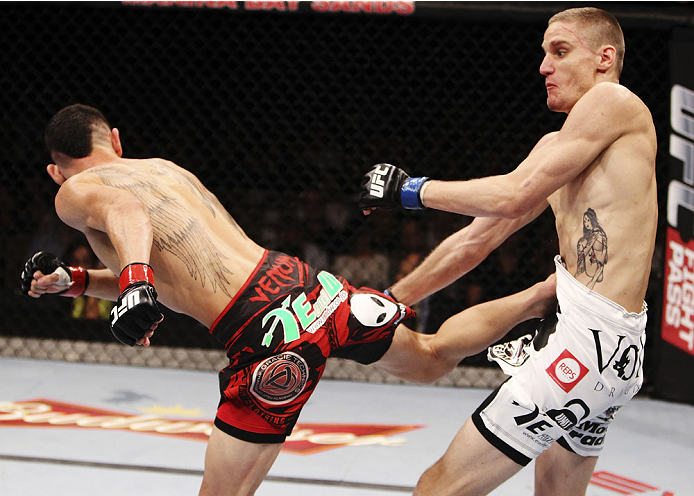 SINGAPORE - JANUARY 04: Max Holloway throws a spinning back kick to Will Chope during their featherweight bout during the UFC Fight Night event at the Marina Bay Sands Resort on January 4, 2014 in Singapore. (Photo by Mitch Viquez/Zuffa LLC/Zuffa LLC via