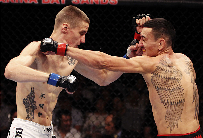 SINGAPORE - JANUARY 04: (L-R) Will Chope and Max Holloway face off in their featherweight bout during the UFC Fight Night event at the Marina Bay Sands Resort on January 4, 2014 in Singapore. (Photo by Mitch Viquez/Zuffa LLC/Zuffa LLC via Getty Images)