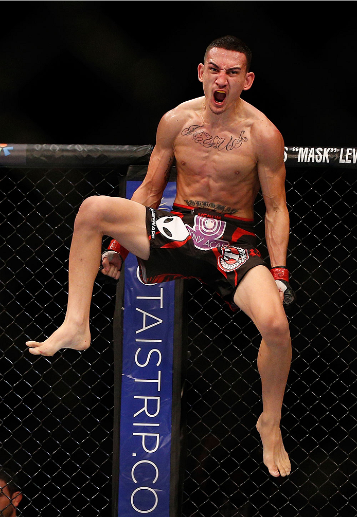 SINGAPORE - JANUARY 04: Max Holloway reacts after his TKO victory over Will Chope in their featherweight bout during the UFC Fight Night event at the Marina Bay Sands Resort on January 4, 2014 in Singapore. (Photo by Josh Hedges/Zuffa LLC/Zuffa LLC via G