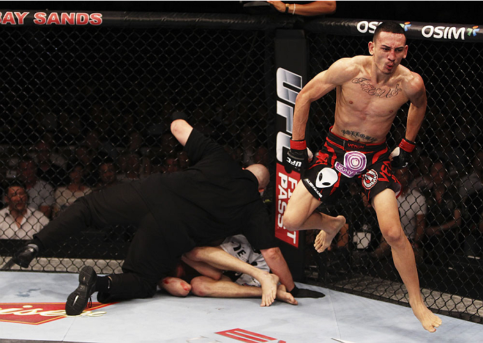 SINGAPORE - JANUARY 04: Max Holloway celebrates his win over Will Chope in their featherweight bout during the UFC Fight Night event at the Marina Bay Sands Resort on January 4, 2014 in Singapore. (Photo by Mitch Viquez/Zuffa LLC/Zuffa LLC via Getty Imag