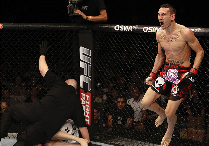 SINGAPORE - JANUARY 04: Max Holloway celebrates his win over Will Chope in their featherweight bout during the UFC Fight Night event at the Marina Bay Sands Resort on January 4, 2014 in Singapore. (Photo by Mitch Viquez/Zuffa LLC/Zuffa LLC via Getty Imag