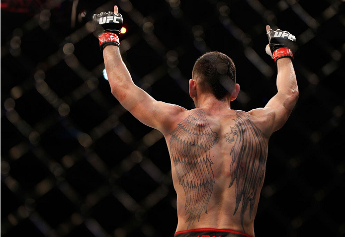 SINGAPORE - JANUARY 04: Max Holloway reacts after his TKO victory over Will Chope in their featherweight bout during the UFC Fight Night event at the Marina Bay Sands Resort on January 4, 2014 in Singapore. (Photo by Josh Hedges/Zuffa LLC/Zuffa LLC via G