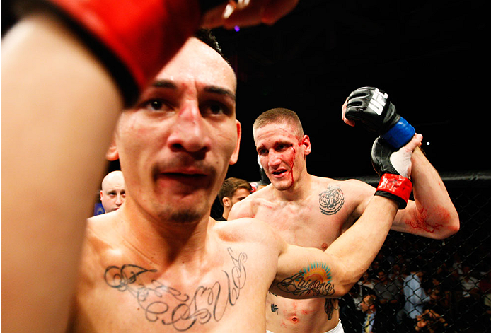 SINGAPORE - JANUARY 04: (L-R) Will Chope and Max Holloway come together after their featherweight bout during the UFC Fight Night event at the Marina Bay Sands Resort on January 4, 2014 in Singapore. (Photo by Mitch Viquez/Zuffa LLC/Zuffa LLC via Getty I