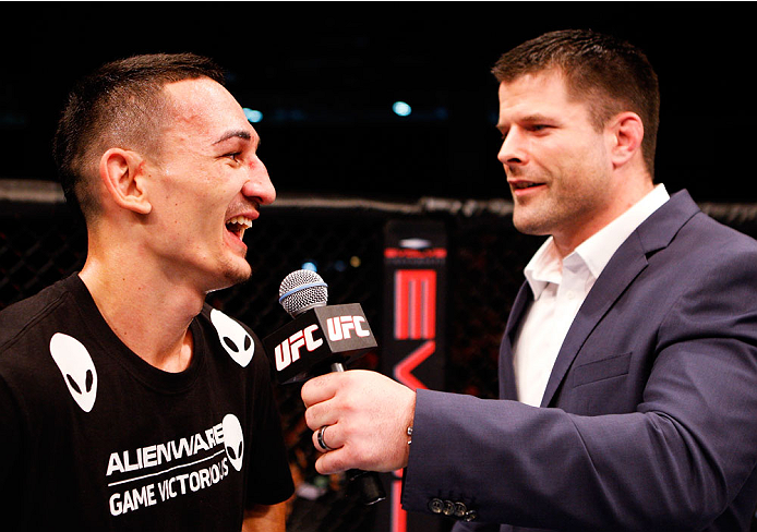 SINGAPORE - JANUARY 04: (L-R) Max Holloway has a laugh with Brian Stann after his win over Will Chope in their featherweight bout during the UFC Fight Night event at the Marina Bay Sands Resort on January 4, 2014 in Singapore. (Photo by Mitch Viquez/Zuff