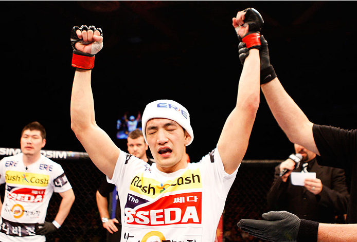 SINGAPORE - JANUARY 04: Kang Kyung Ho celebrates his win over Shunichi Shimizu in their bantamweight bout during the UFC Fight Night event at the Marina Bay Sands Resort on January 4, 2014 in Singapore. (Photo by Mitch Viquez/Zuffa LLC/Zuffa LLC via Gett