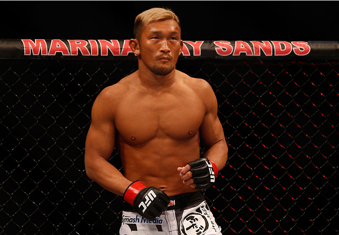 SINGAPORE - JANUARY 04: Kiichi Kunimoto stands in the Octagon before his welterweight bout against Luiz Dutra during the UFC Fight Night event at the Marina Bay Sands Resort on January 4, 2014 in Singapore. (Photo by Josh Hedges/Zuffa LLC/Zuffa LLC via G