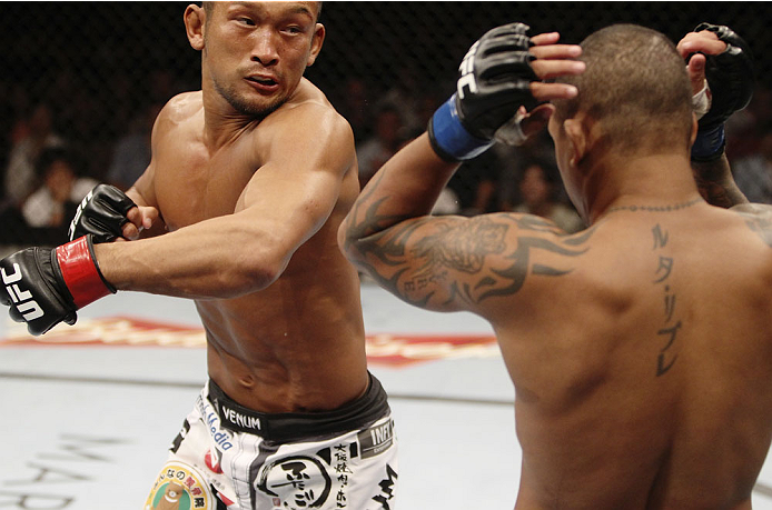 SINGAPORE - JANUARY 04: Kiichi Kunimoto goes for a punch on Luiz Dutra in their welterweight bout during the UFC Fight Night event at the Marina Bay Sands Resort on January 4, 2014 in Singapore. (Photo by Mitch Viquez/Zuffa LLC/Zuffa LLC via Getty Images)
