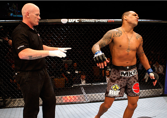 SINGAPORE - JANUARY 04: Luiz Dutra reacts after he was disqualified for illegal elbows to the back of the head of his opponent, Kiichi Kunimoto, in their welterweight bout during the UFC Fight Night event at the Marina Bay Sands Resort on January 4, 2014