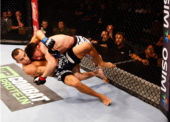 SINGAPORE - JANUARY 04: Tatsuya Kawajiri goes for a takedown on Sean Soriano in their featherweight bout during the UFC Fight Night event at the Marina Bay Sands Resort on January 4, 2014 in Singapore. (Photo by Mitch Viquez/Zuffa LLC/Zuffa LLC via Get