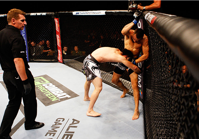 SINGAPORE - JANUARY 04: Sean Soriano throws elbows down on Tatsuya Kawajiri in their featherweight bout during the UFC Fight Night event at the Marina Bay Sands Resort on January 4, 2014 in Singapore. (Photo by Mitch Viquez/Zuffa LLC/Zuffa LLC via Getty