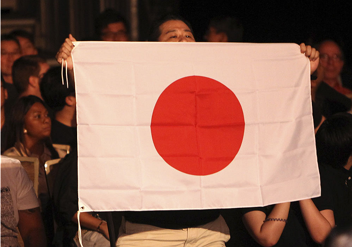 SINGAPORE - JANUARY 04: A fan holds a Japanese flag during Katsunori Kikuno and Quinn Mulhern's during their lightweight bout during the UFC Fight Night event at the Marina Bay Sands Resort on January 4, 2014 in Singapore. (Photo by Mitch Viquez/Zuffa LL