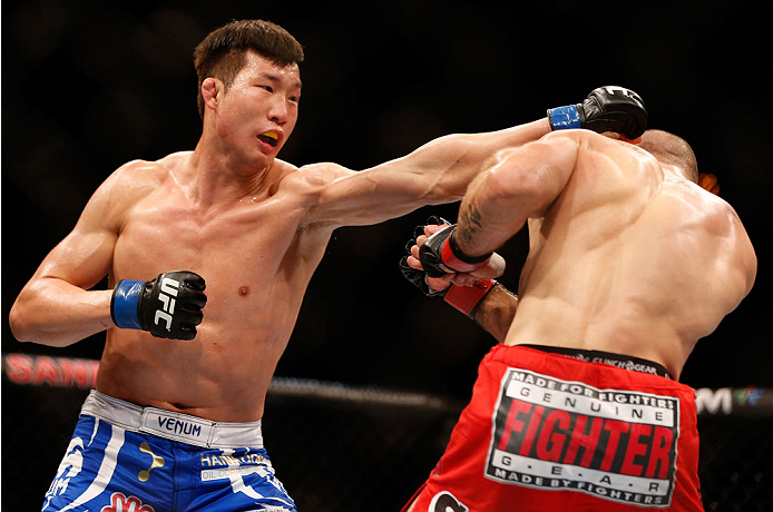 SINGAPORE - JANUARY 04: (L-R) Lim Hyun Gyu punches Tarec Saffiedine in their welterweight bout during the UFC Fight Night event at the Marina Bay Sands Resort on January 4, 2014 in Singapore. (Photo by Josh Hedges/Zuffa LLC/Zuffa LLC via Getty Images)