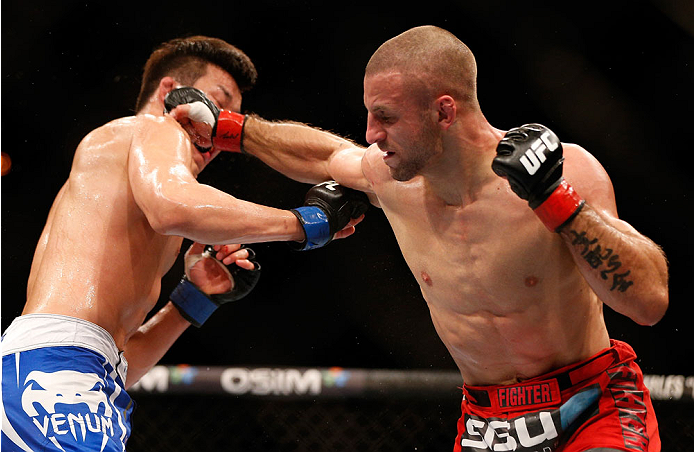 SINGAPORE - JANUARY 04: (R-L) Tarec Saffiedine punches Lim Hyun Gyu in their welterweight bout during the UFC Fight Night event at the Marina Bay Sands Resort on January 4, 2014 in Singapore. (Photo by Josh Hedges/Zuffa LLC/Zuffa LLC via Getty Images)