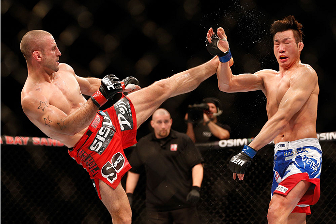 SINGAPORE - JANUARY 04: (L-R) Tarec Saffiedine kicks Lim Hyun Gyu in their welterweight bout during the UFC Fight Night event at the Marina Bay Sands Resort on January 4, 2014 in Singapore. (Photo by Josh Hedges/Zuffa LLC/Zuffa LLC via Getty Images)