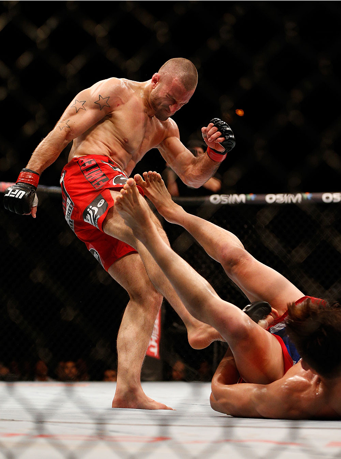 SINGAPORE - JANUARY 04: (L-R) Tarec Saffiedine kicks Lim Hyun Gyu in their welterweight bout during the UFC Fight Night event at the Marina Bay Sands Resort on January 4, 2014 in Singapore. (Photo by Josh Hedges/Zuffa LLC/Zuffa LLC via Getty Images)