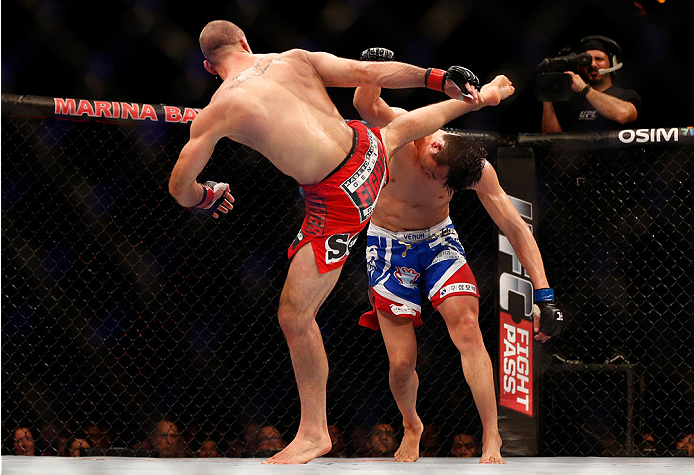SINGAPORE - JANUARY 04: (L-R) Tarec Saffiedine kicks Lim Hyun Gyu in their welterweight bout during the UFC Fight Night event at the Marina Bay Sands Resort on January 4, 2014 in Singapore. (Photo by Josh Hedges/Zuffa LLC/Zuffa LLC via Getty Images)