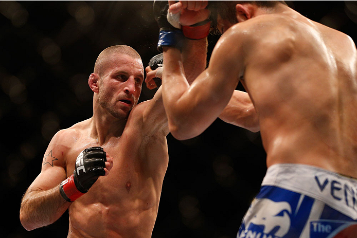 SINGAPORE - JANUARY 04: (L-R) Tarec Saffiedine punches Lim Hyun Gyu in their welterweight bout during the UFC Fight Night event at the Marina Bay Sands Resort on January 4, 2014 in Singapore. (Photo by Josh Hedges/Zuffa LLC/Zuffa LLC via Getty Images)
