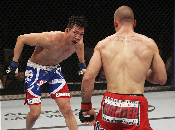 SINGAPORE - JANUARY 04: Lim Hyun Gyu reacts after a number of leg kicks weakened from Tarec Saffiedine in their welterweight bout during the UFC Fight Night event at the Marina Bay Sands Resort on January 4, 2014 in Singapore. (Photo by Mitch Viquez/Zuff