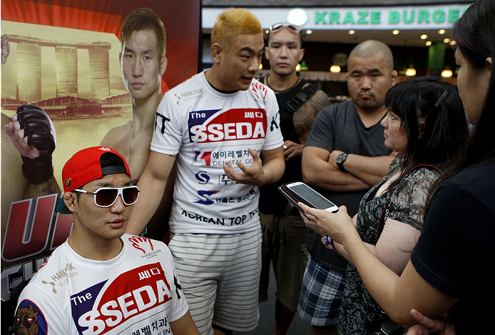 SINGAPORE - JANUARY 02: Hyun Gyu Lim interacts with media during the UFC Fight Night Singapore Ultimate Media Day at the Shoppes at Marina Bay Sands on January 2, 2014 in Singapore. (Photo by Mitch Viquez/Zuffa LLC/Zuffa LLC via Getty Images)