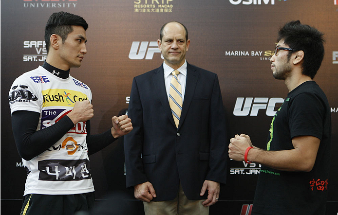 SINGAPORE - JANUARY 02: (L-R) Opponents Kyung Ho Kang and Shunichi Shimitzu face off during the UFC Fight Night Singapore Ultimate Media Day at the Shoppes at Marina Bay Sands on January 2, 2014 in Singapore. (Photo by Mitch Viquez/Zuffa LLC/Zuffa LLC vi