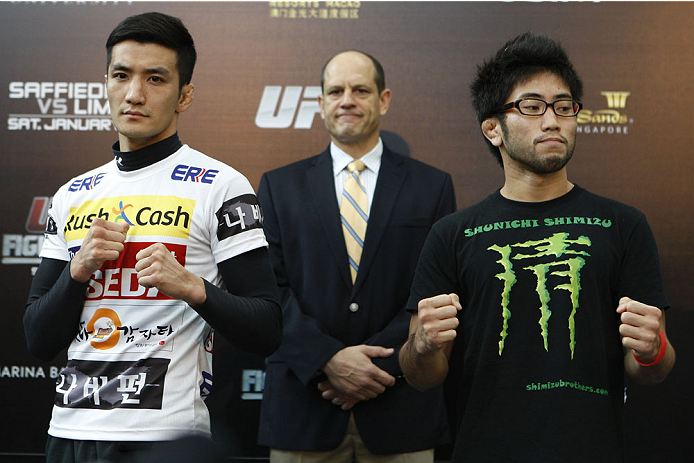 SINGAPORE - JANUARY 02: (L-R) Opponents Kyung Ho Kang and Shunichi Shimitzu pose for photos during the UFC Fight Night Singapore Ultimate Media Day at the Shoppes at Marina Bay Sands on January 2, 2014 in Singapore. (Photo by Mitch Viquez/Zuffa LLC/Zuffa