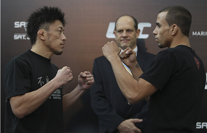 SINGAPORE - JANUARY 02: (L-R) Opponents Tatsuya Kawajiri and Sean Soriano face off during the UFC Fight Night Singapore Ultimate Media Day at the Shoppes at Marina Bay Sands on January 2, 2014 in Singapore. (Photo by Mitch Viquez/Zuffa LLC/Zuffa LLC via