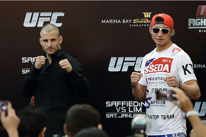 SINGAPORE - JANUARY 02: (L-R) Tarec Saffiedine and Lim Hyun Gyu pose during the UFC Fight Night Singapore Ultimate Media Day at the Skating Rink at The Shoppes at Marina Bay Sand on January 2, 2014 in Singapore. (Photo by Suhaimi Abdullah/Zuffa LLC)